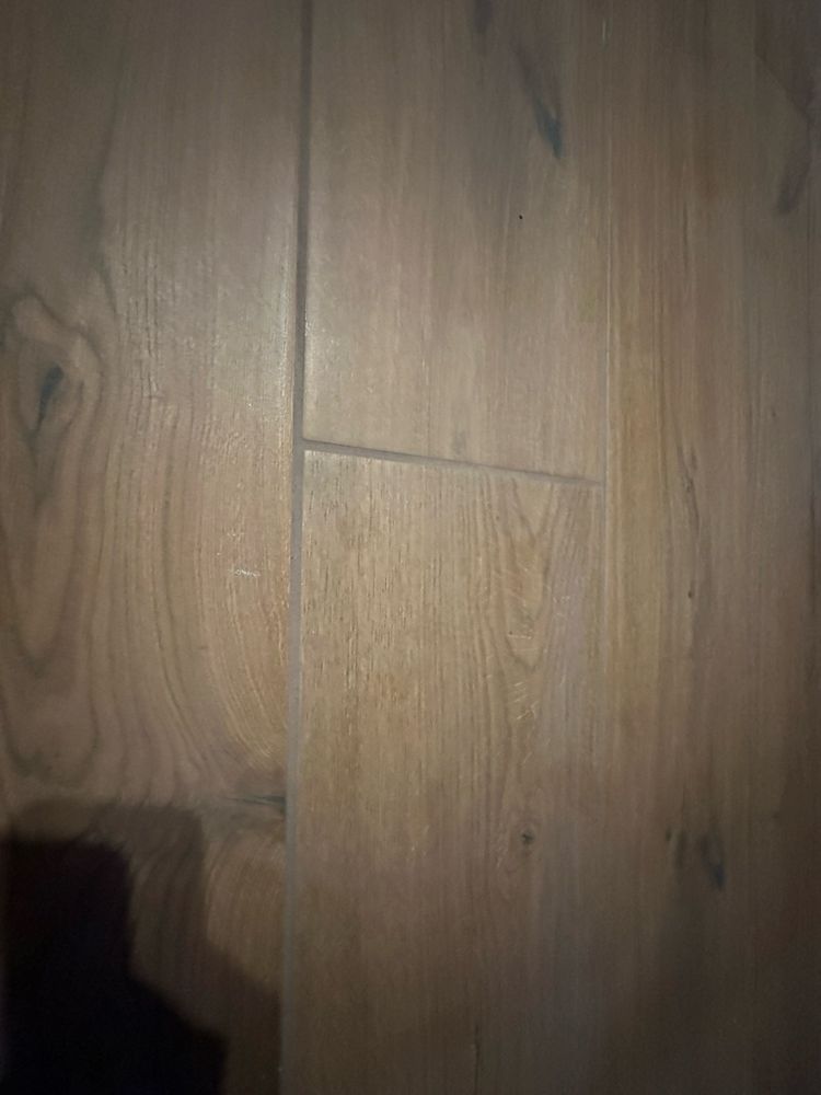 Close-up of light brown wooden floorboards with visible grain and seams