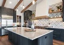 Modern kitchen with island, white marble counters, dark cabinets, and exposed wood beams