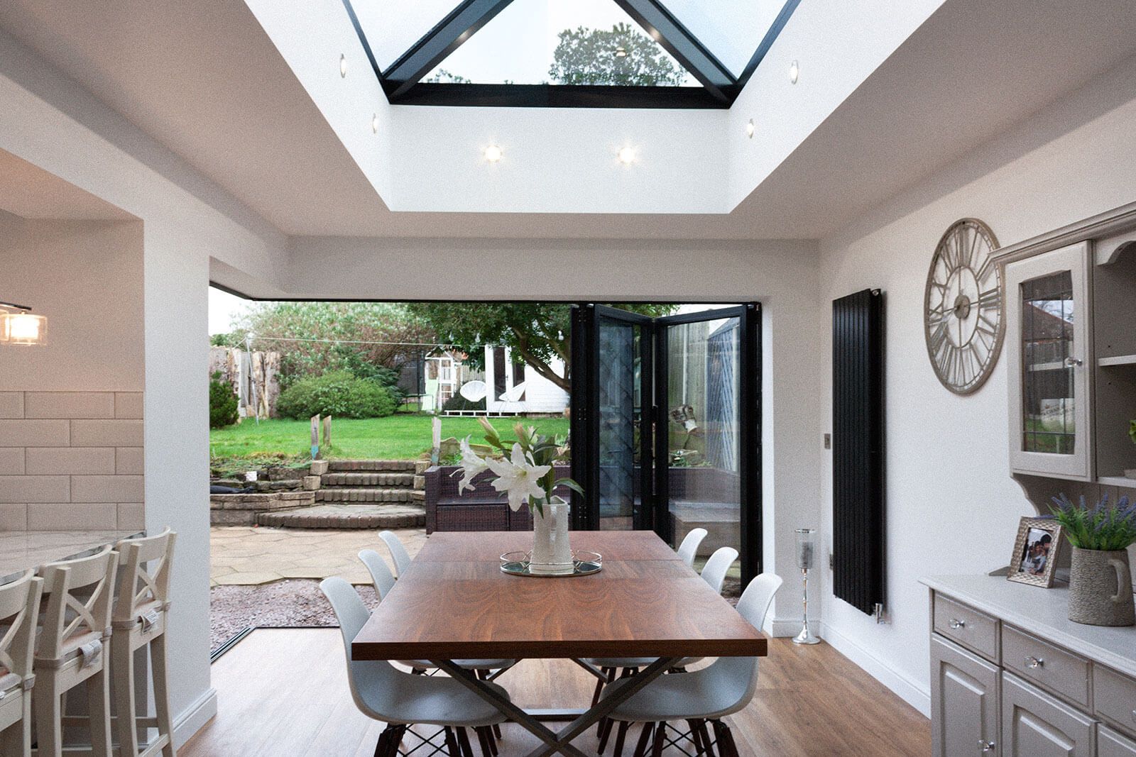 Dining area looking out through bi-fold doors of house extension