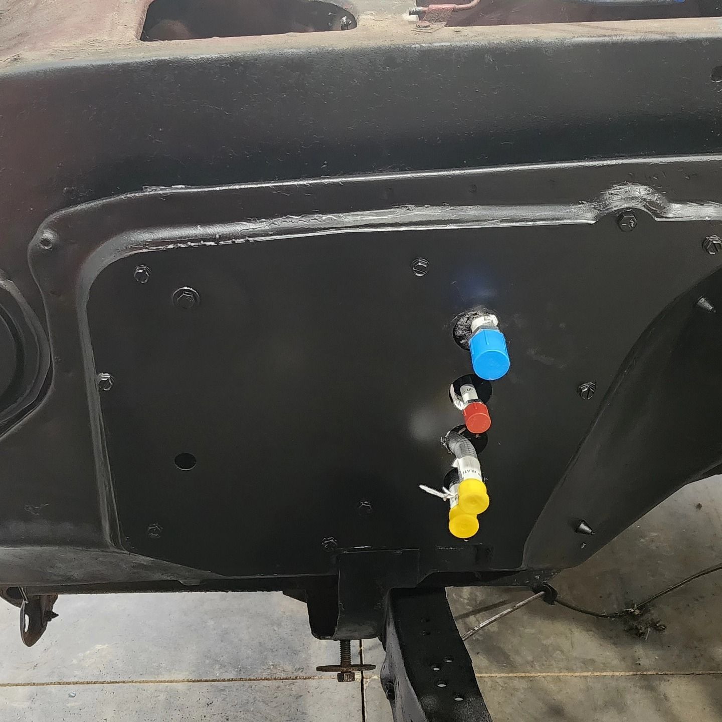 Black machinery panel with three color-coded connectors: blue, red, and yellow.
