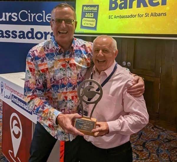 Peter Barker is being presented with the Ambassador of the Year Award by Nigel Botterill