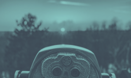 Coin-operated viewer looking toward a bright point on the horizon, trees and cloudy sky, teal overlay.