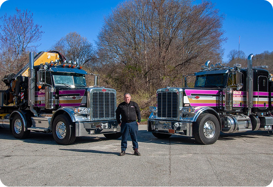 A person between two trucks | Mal's Auto & Truck Repair