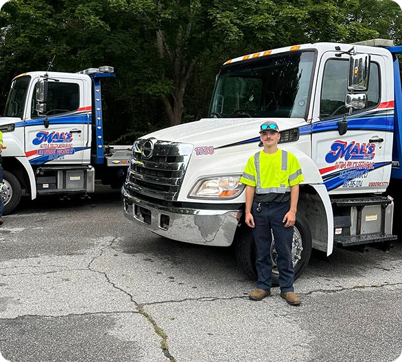 A person infront of a truck | Mal's Auto & Truck Repair