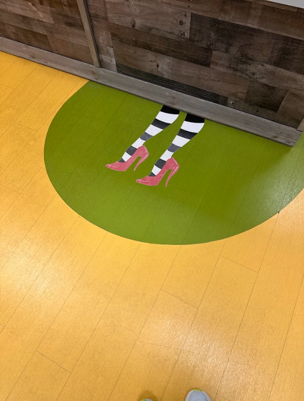 A witch 's legs are painted on the floor in a circle.
