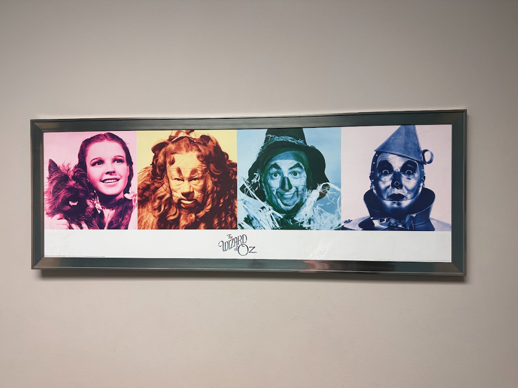 A framed picture of the wizard of oz characters