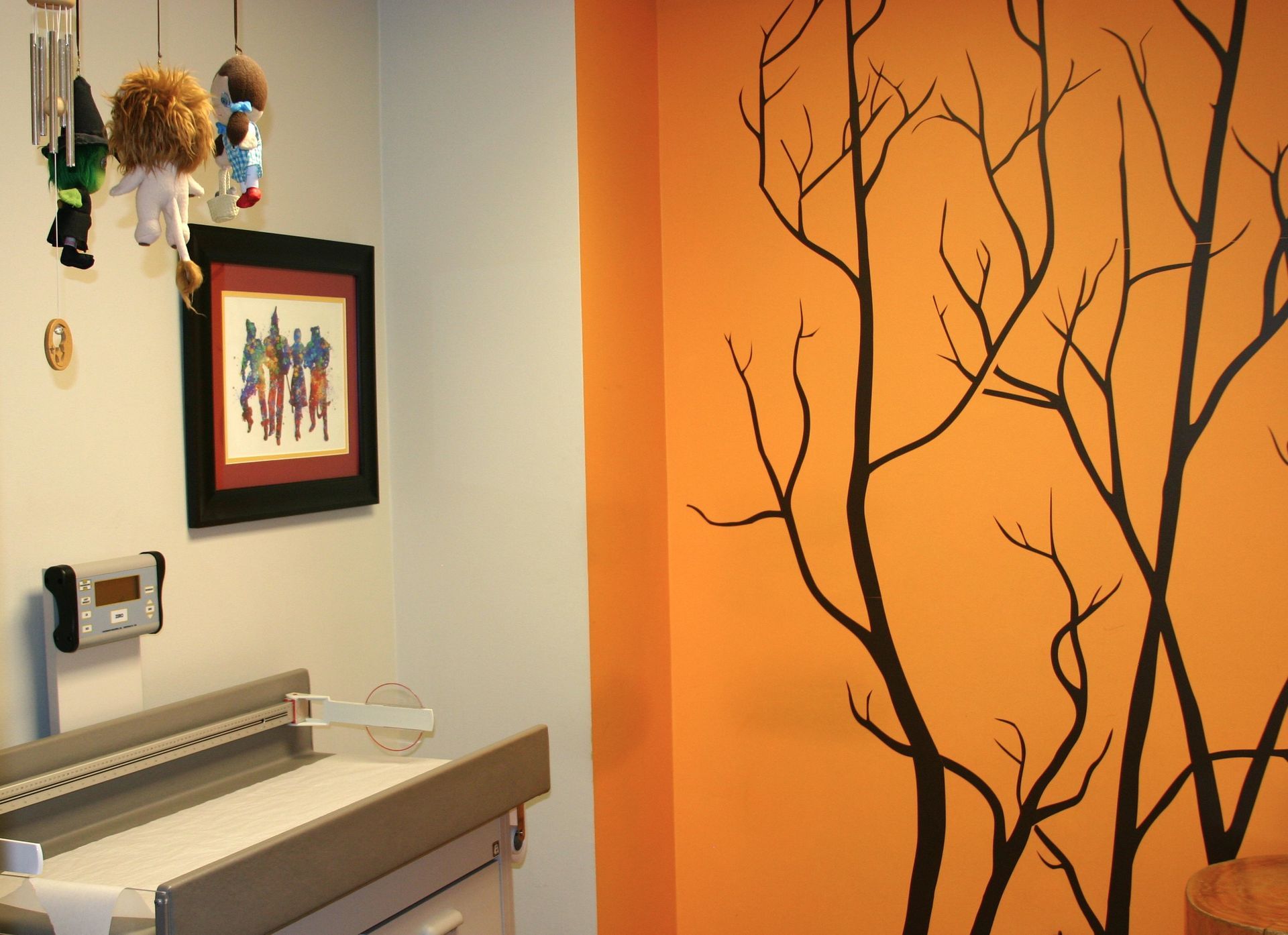 An orange wall with a picture of a family on it