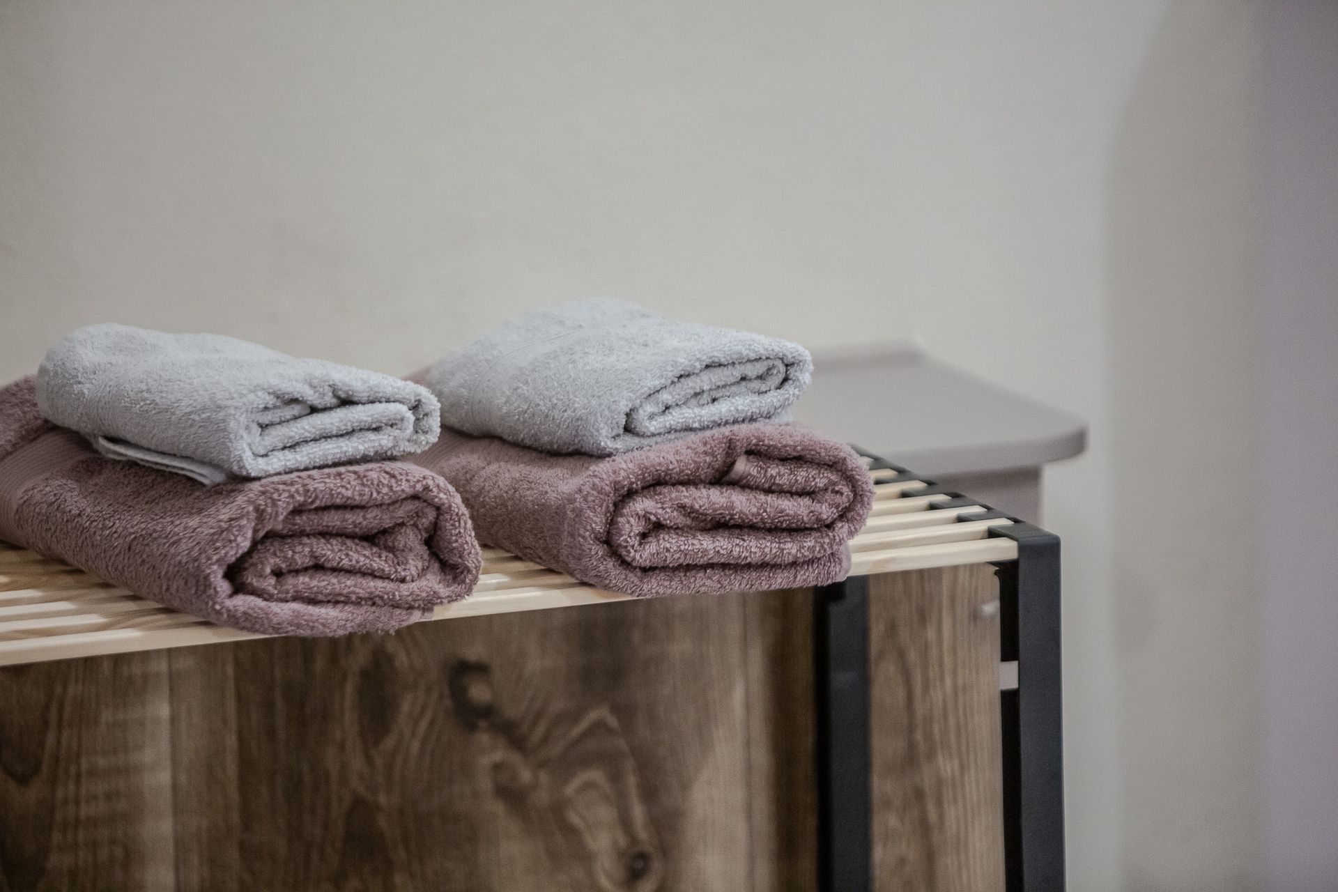 Stacked folded towels on a shelf in a bathroom or spa setting