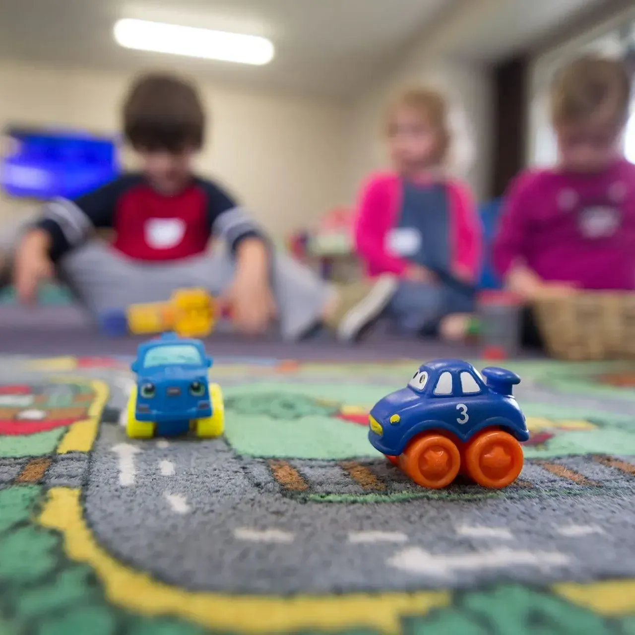 A blue toy car with the number 3 on it