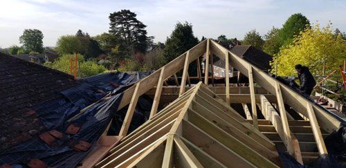 Timber frame of roof being installed on domestic property