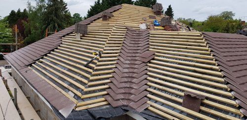 Tiled roof installation underway