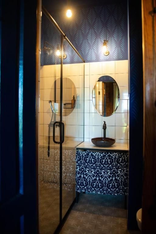 A private bathroom with a sink a mirror and a walk in modern shower in Shromantic Garden.