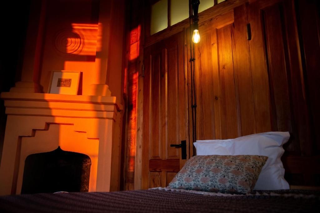 Shromantic Garden Blue room - double room - a private bedroom with a bed , fireplace and wooden walls.