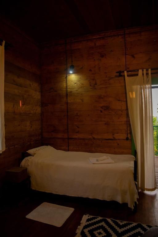Private bedroom with a single bed in the middle of the room.
