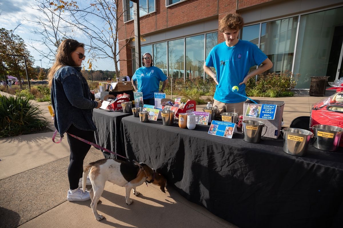 Guest and dog in front of raffle table