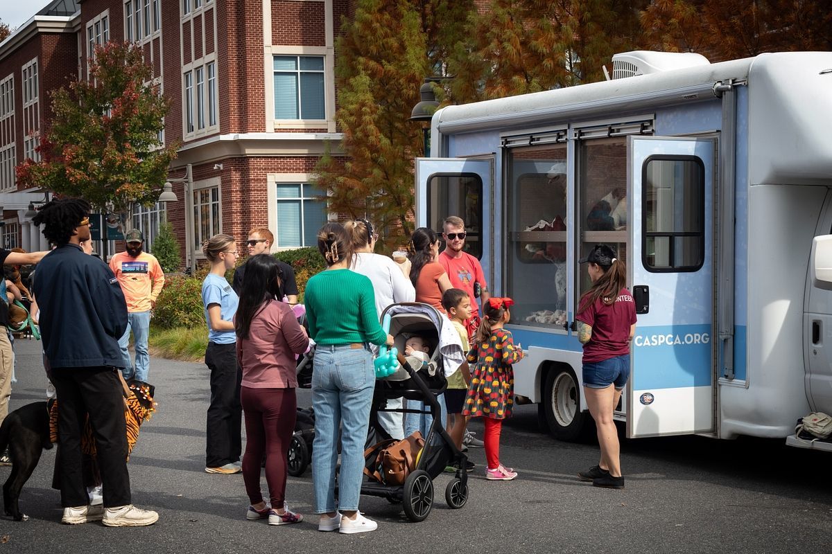 Guests waiting in line to see dogs in CASPCA Care-a-Van