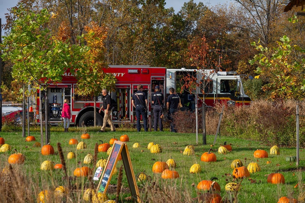 Fire truck parked in front of pumpkin patch