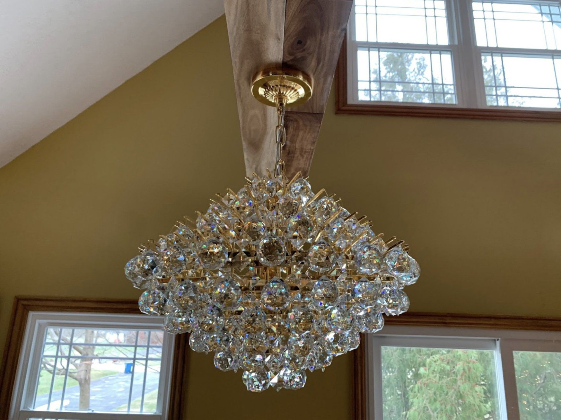 A large chandelier is hanging from the ceiling in a room