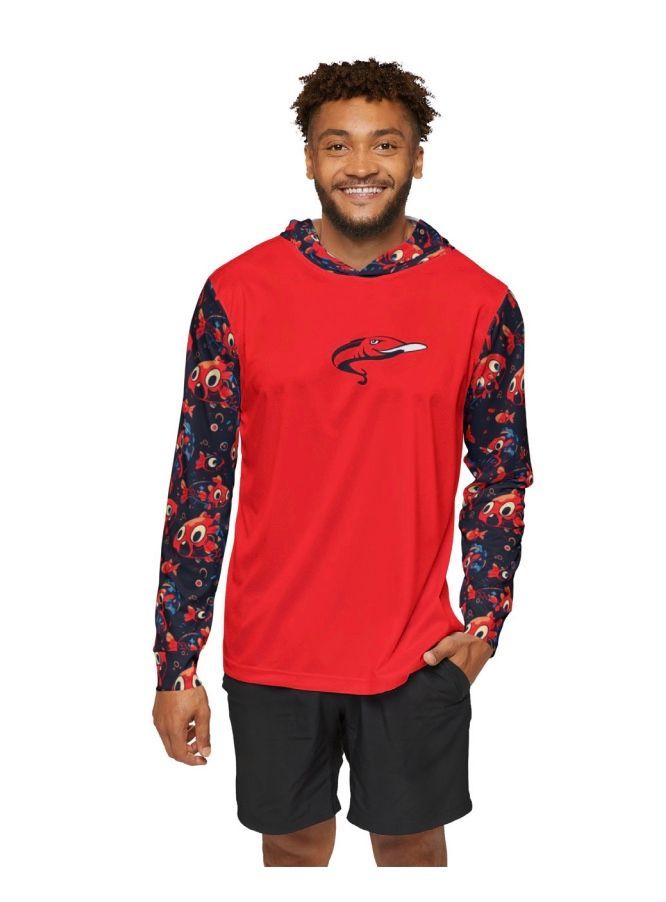 Man wearing a red hooded shirt with floral sleeves and black shorts, smiling.