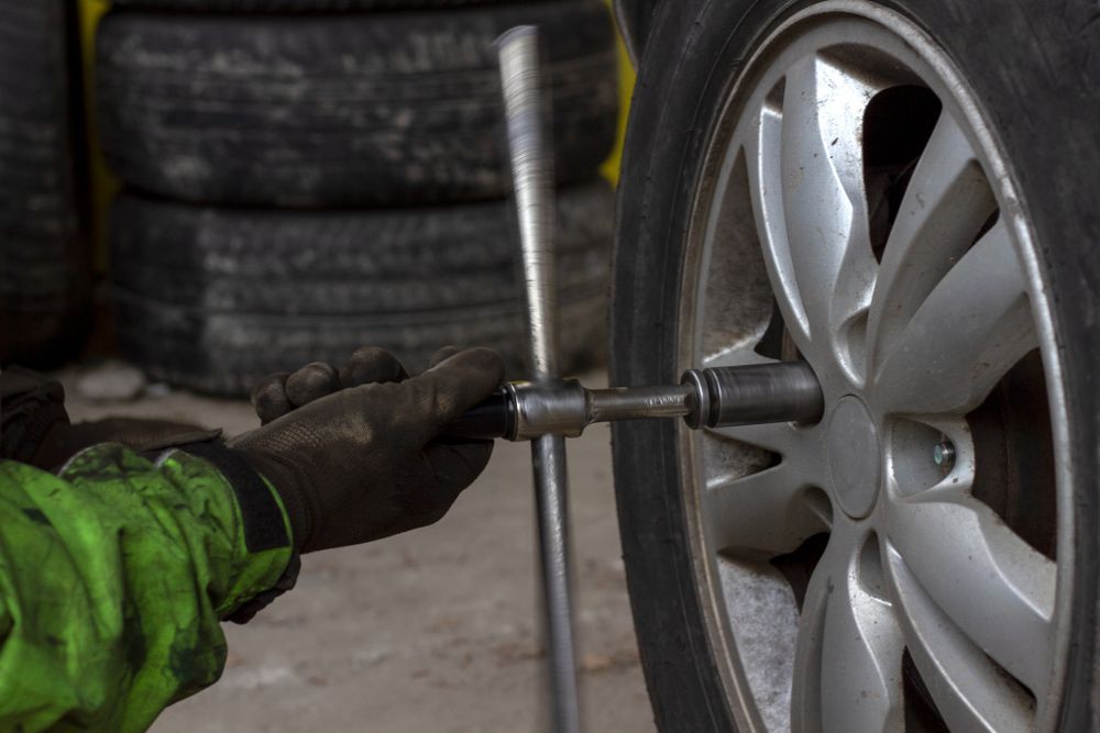 Unscrewing Nuts From Wheel Disc During Advanced Automotive Services — Advanced Automotive Services In Earlville, QLD