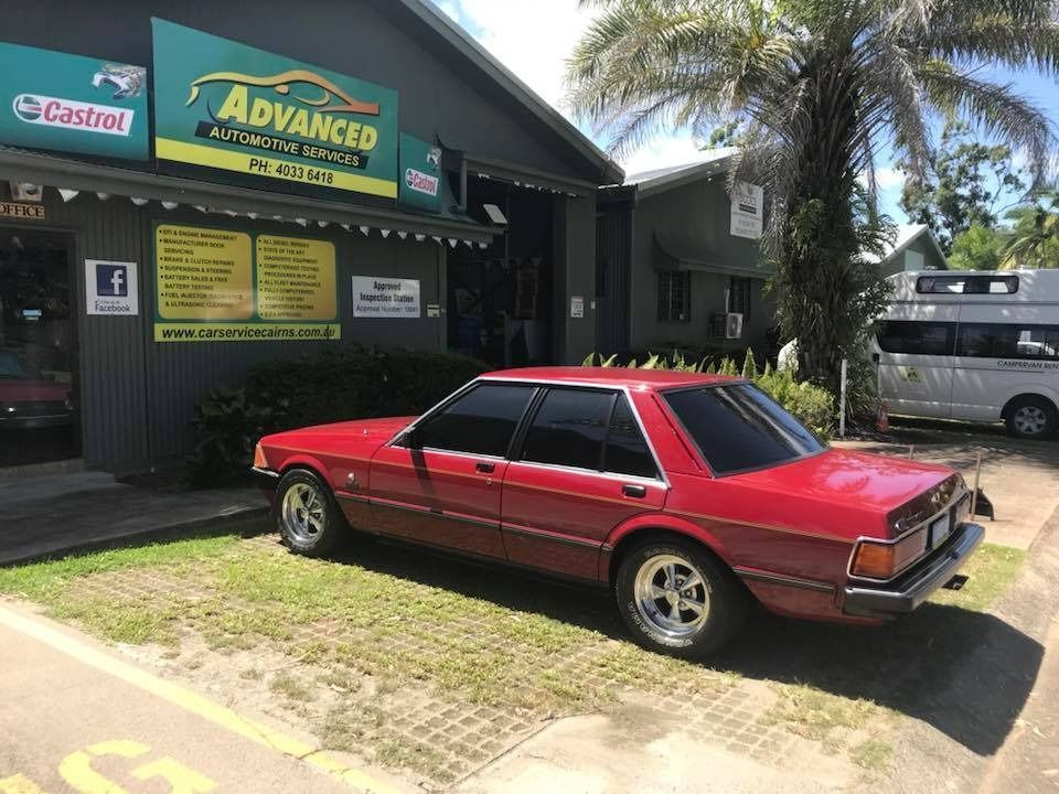 A Red Car Is Parked In Front Of An Advanced Auto Repair Shop — Advanced Automotive Services In Innisfail, QLD