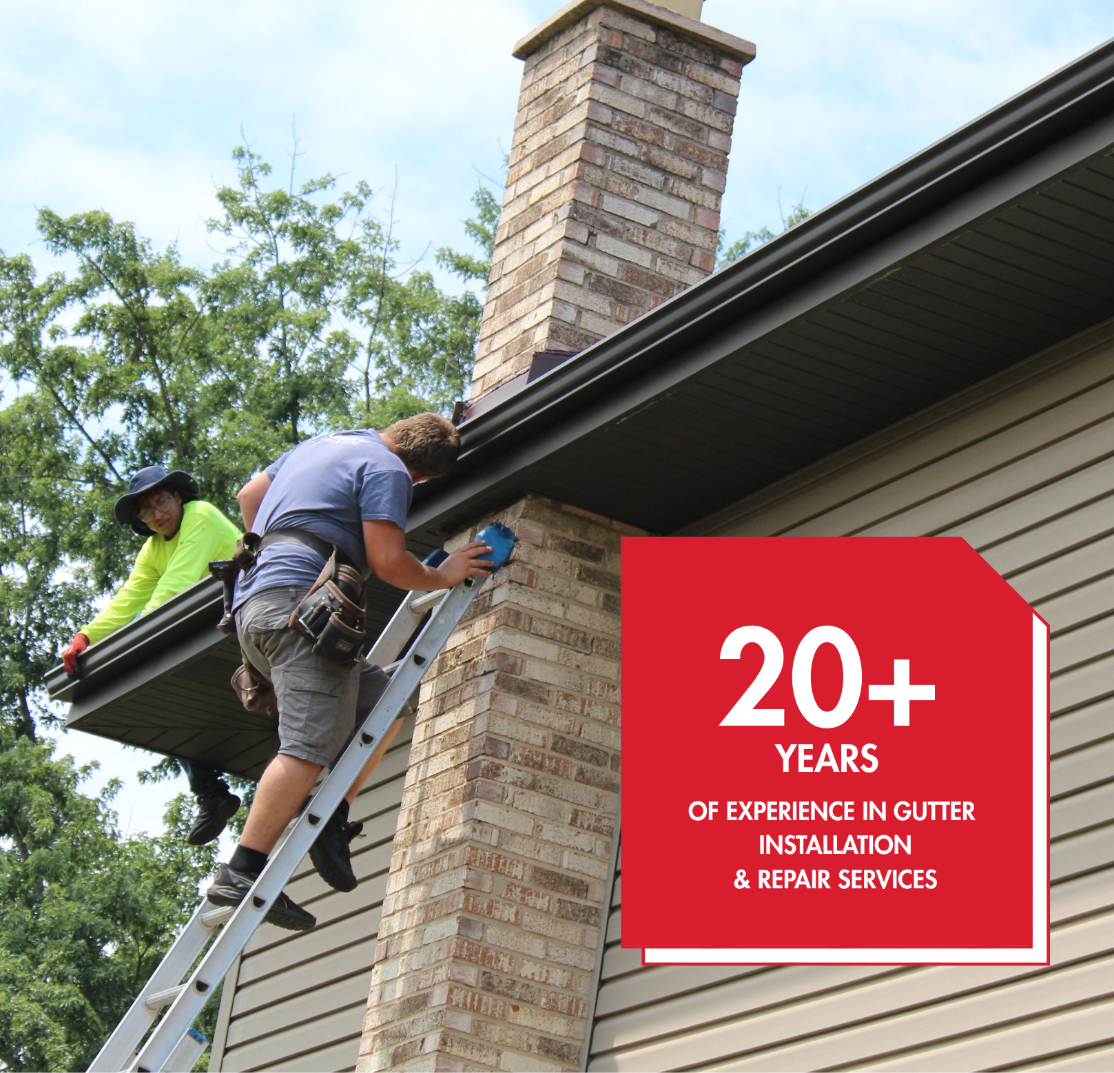 Two workers installing gutters on a house, one on a ladder, red logo: