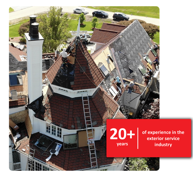 Roofing crew working on a house with a steep roof; 20+ years experience.
