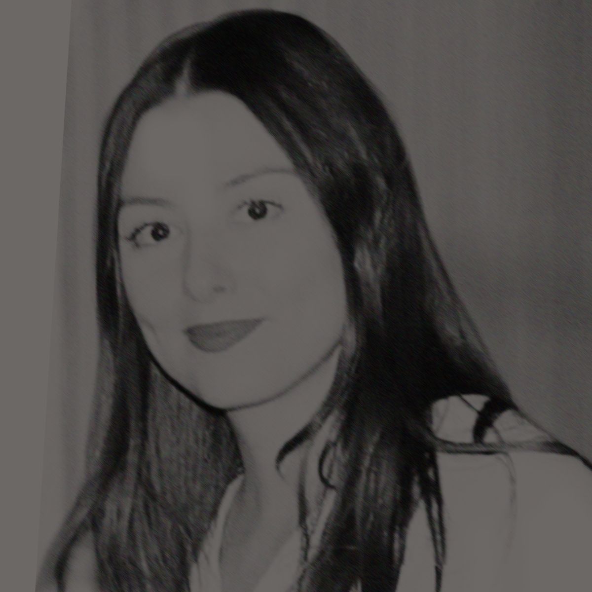 Woman with long brown hair and red lipstick smiling, looking at the camera.