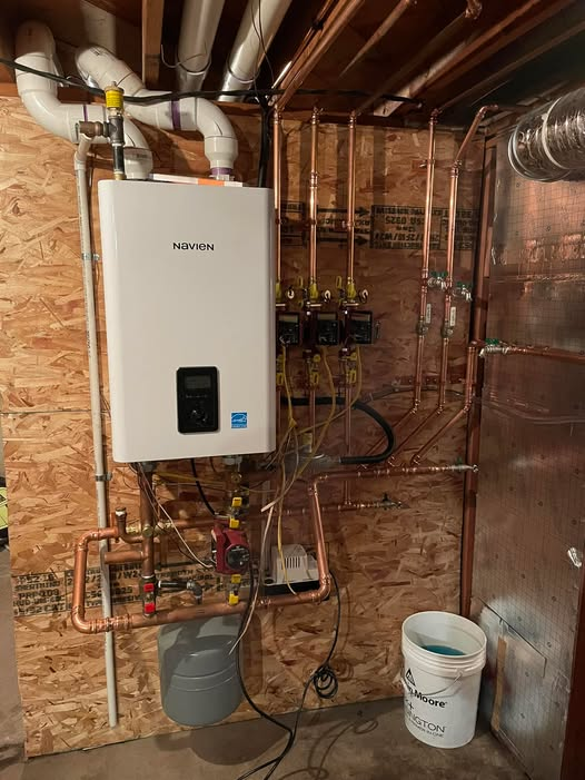 Person Working on Air Conditioning Unit — Breezy Point, MN — JM Heating & Air Person Working on Air Conditioning Unit — Breezy Point, MN — JM Heating & Air