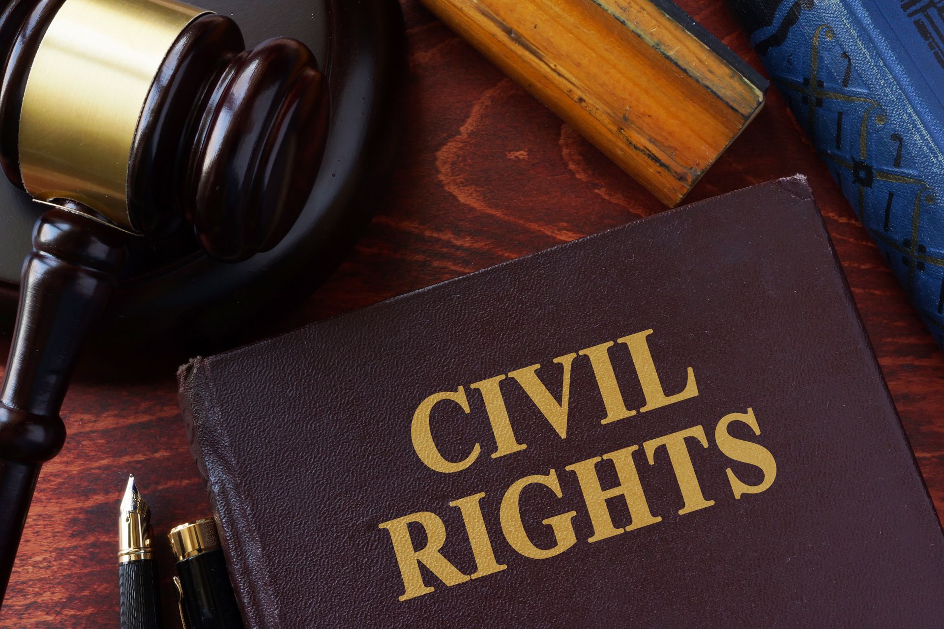 Civil rights book beside a judge’s gavel and law books