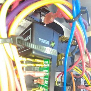 Close-up of a computer power supply and colorful internal wires connected to circuit boards.