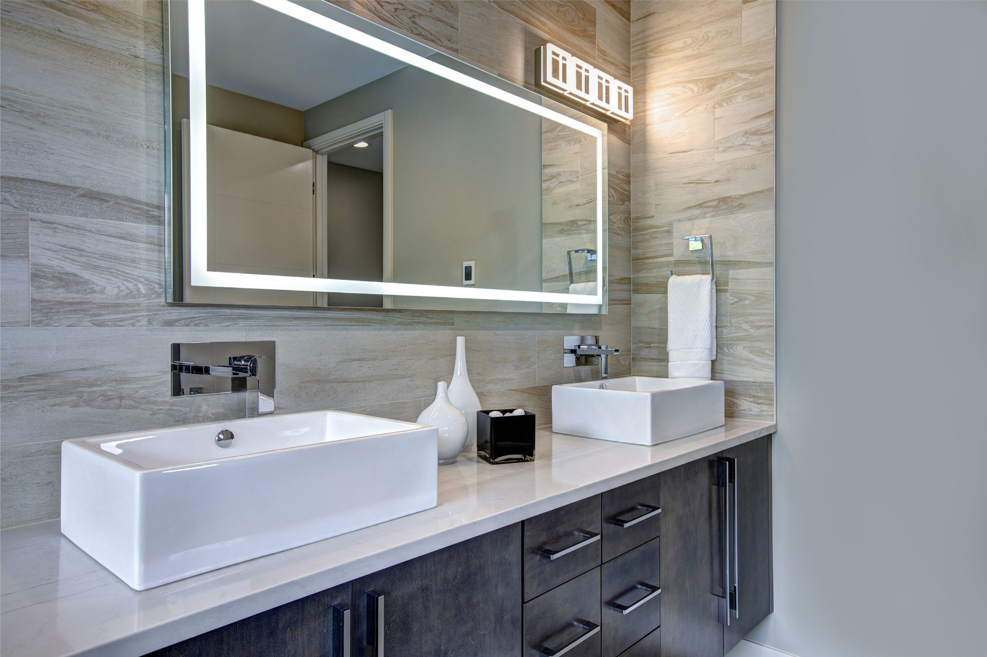 a bathroom with two sinks and a large mirror
