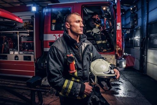 Firefighter holding a helmet