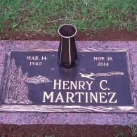 Gravestone for Henry C. Martinez with bronze vase and engraved birth and death dates