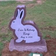 Rabbit-shaped gravestone with the name “Erin Whitney King” and date “Aug 6 2014” on grass