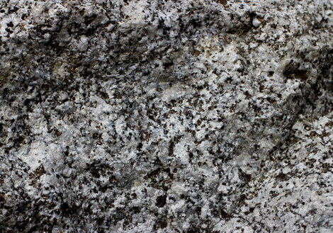 Close-up of gray, black, and white speckled stone or granite surface