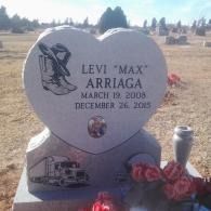 Heart-shaped gravestone for Levi “Max” Arriaga with red flowers in a cemetery