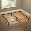 A bed frame is sitting on a wooden floor in a room next to a window.