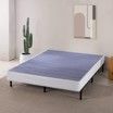 A bed frame with a mattress on top of it in a bedroom.