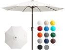A white umbrella is sitting next to a bunch of different colored umbrellas.