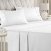 A bed with white sheets and pillows in a bedroom.
