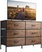 A wooden dresser with a flat screen tv on top of it.