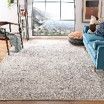 A living room with a couch , chair , and rug.