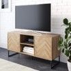 A flat screen tv is sitting on top of a wooden entertainment center in a living room.