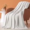 A white blanket is sitting on top of a chair.