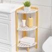 A bathroom with a wooden shelf with towels and candles on it.