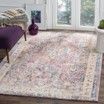 A living room with a rug on the floor and a purple bench.