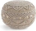A close up of a crocheted ottoman on a white background.