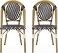 A pair of wicker chairs on a white background.