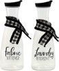 Two clear bottles with black and white plaid ribbons on them.